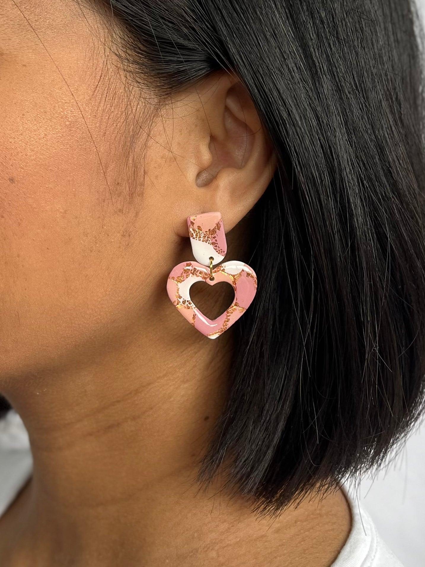 Example of heart dangle earring on models ear