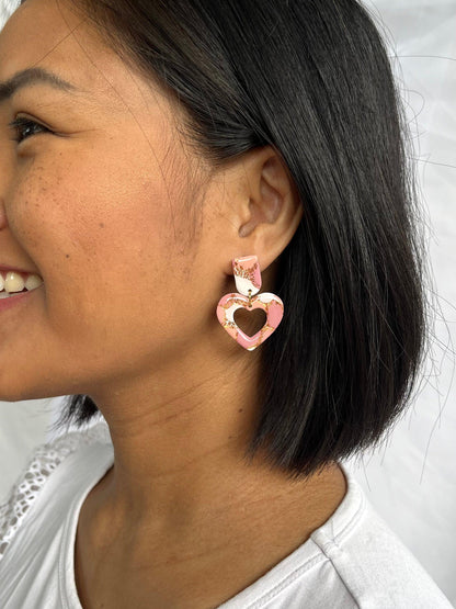 Example of heart dangle earring on models ear