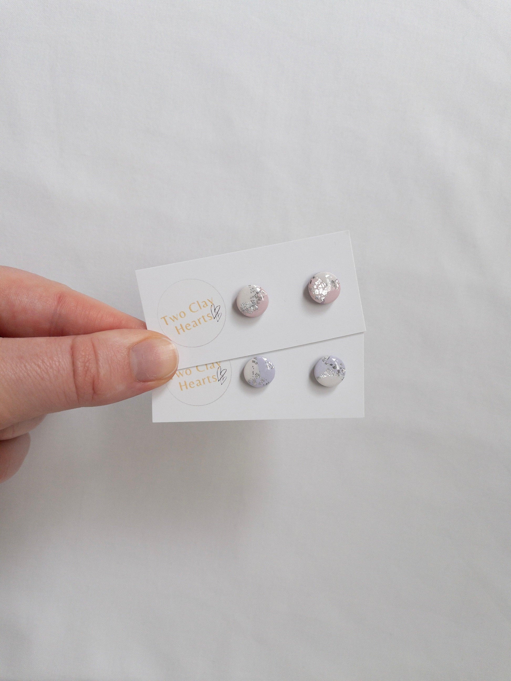 Mini pastel and silver circle stud earrings on white backing card