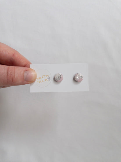 Mini pink and silver circle stud earrings on white backing card