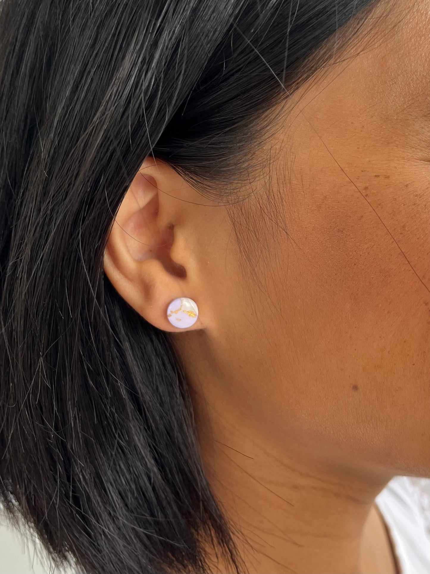 Example of mini circle stud earring on models ear