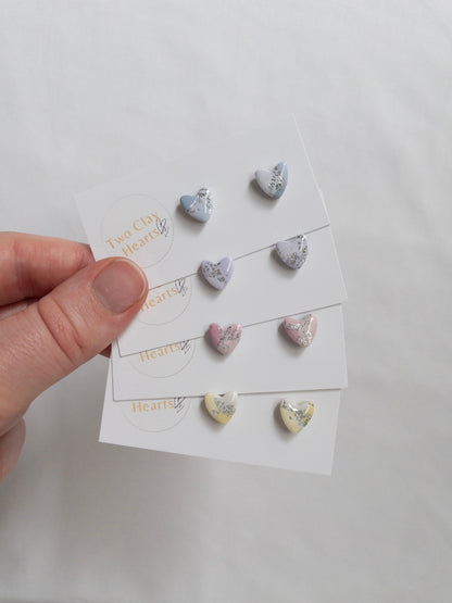 Mini pastel and silver heart stud earrings on white card