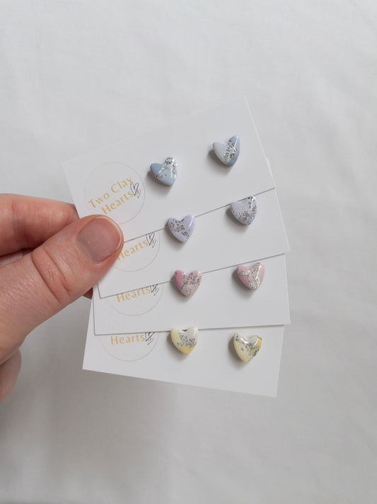 Mini pastel and silver heart stud earrings on white card