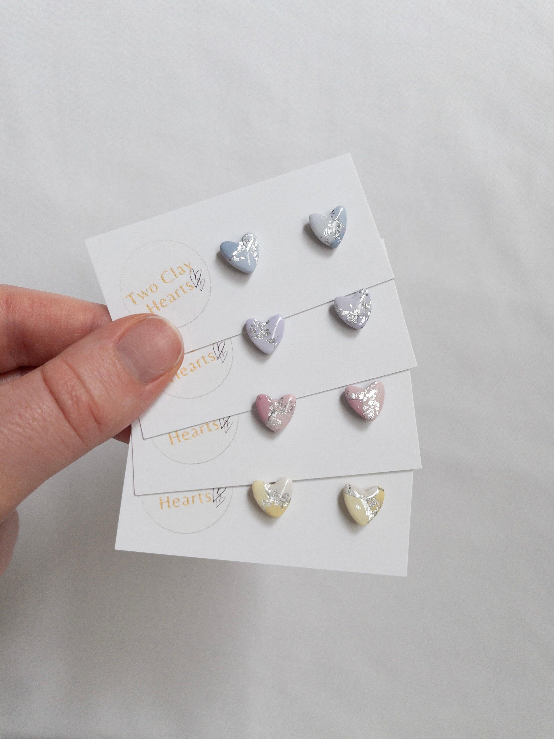 Mini pastel and silver heart stud earrings on white card