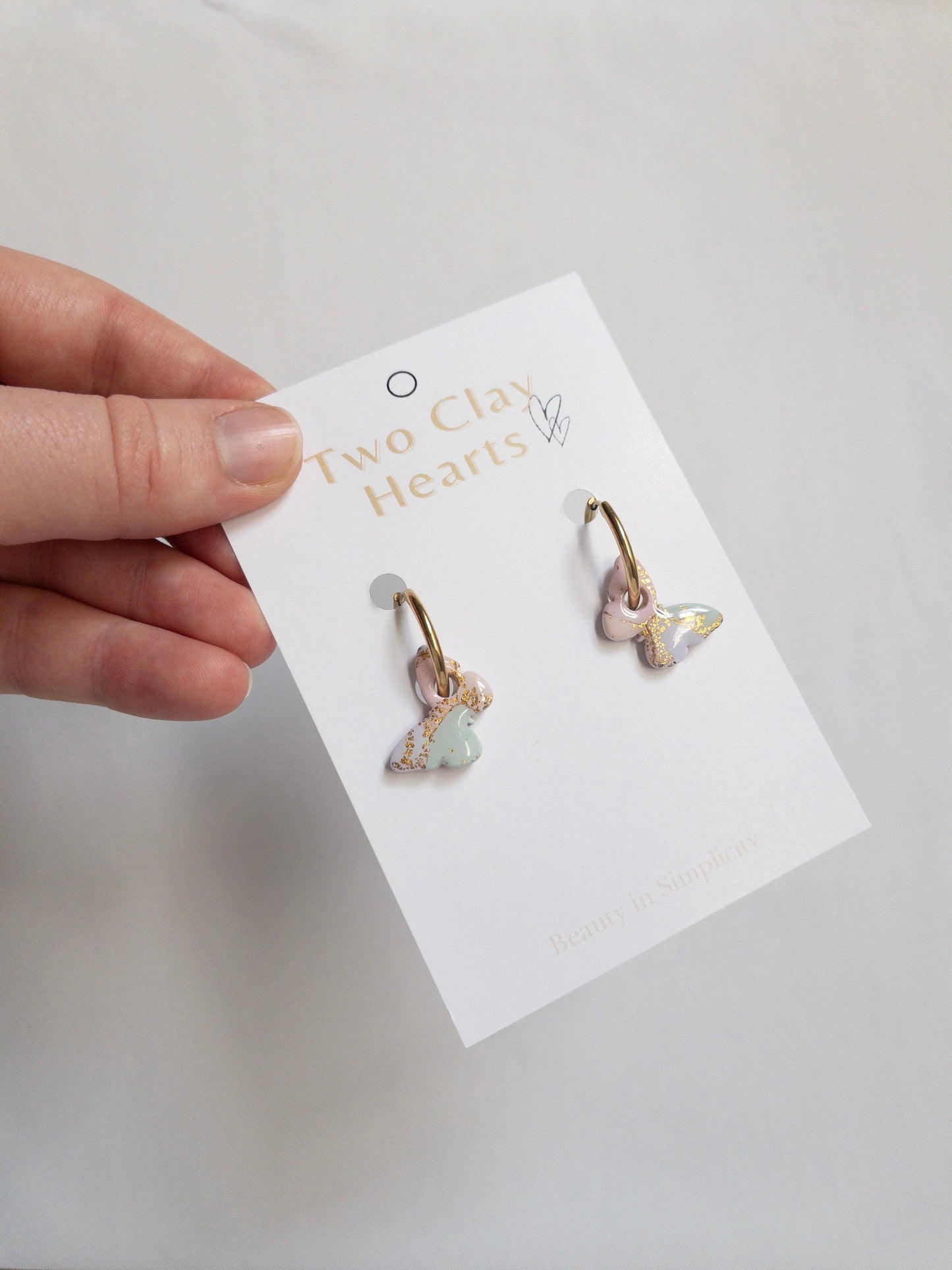 multicoloured pastel rainbow butterfly hoop earrings with shiny gold speckles