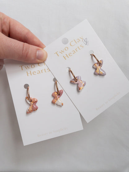 Rose gold butterfly hoop earrings on backing cards