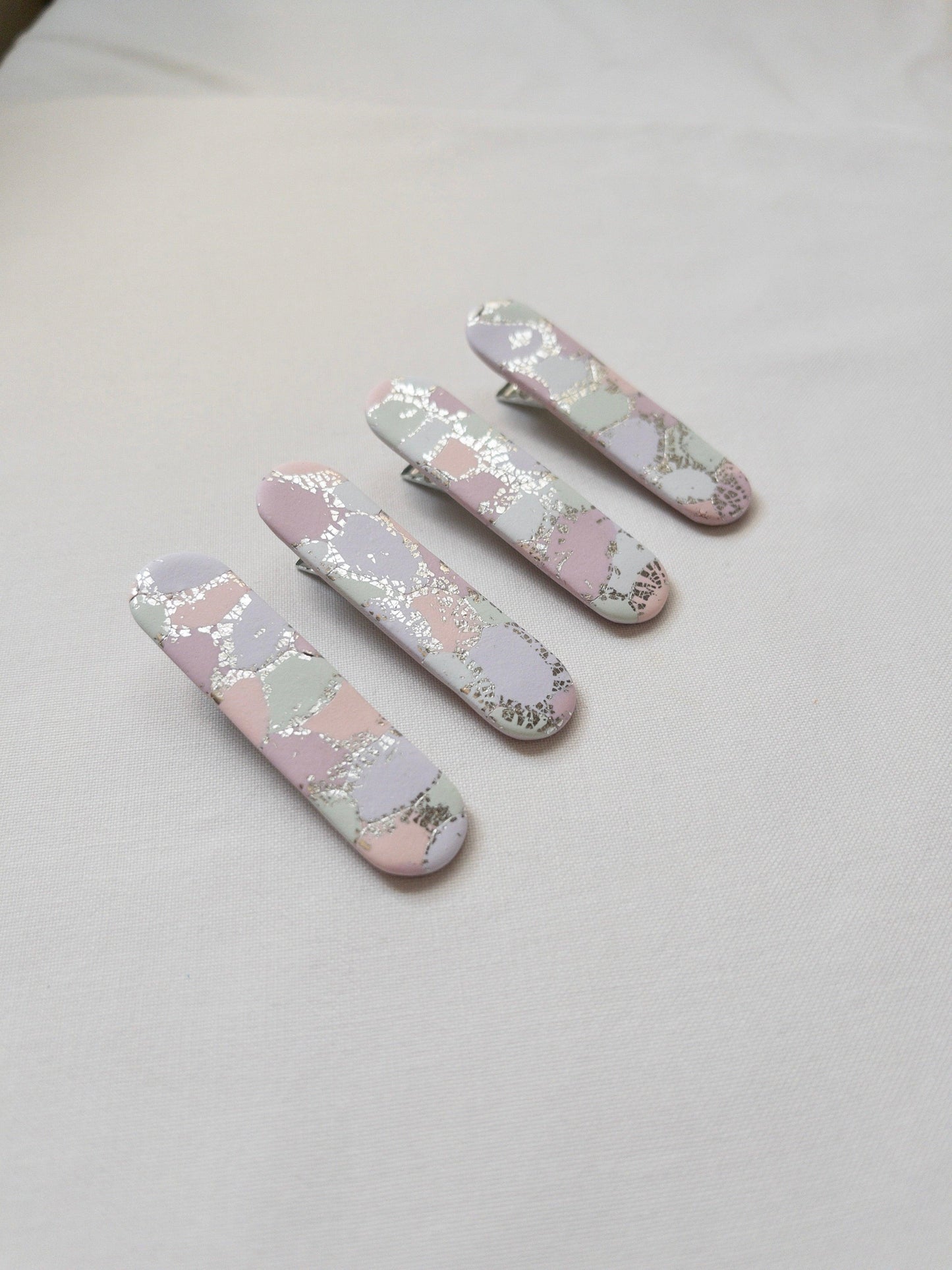 pastel rainbow coloured hair clips with silver flecks that are shining in the sun