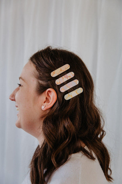 four oblong polymer clay hair clips in a models hair