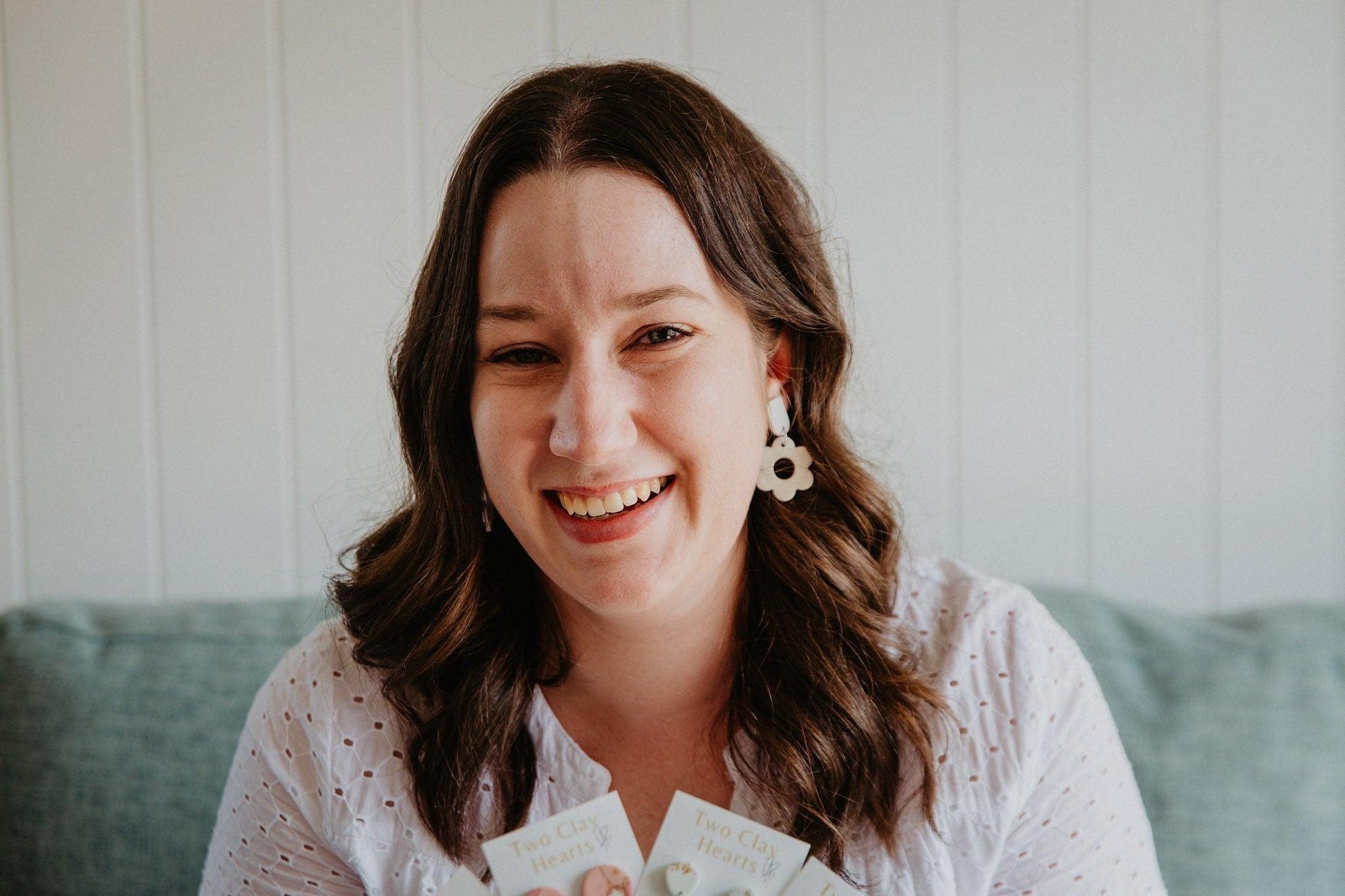 Pastel flower shaped dangles worn on a model