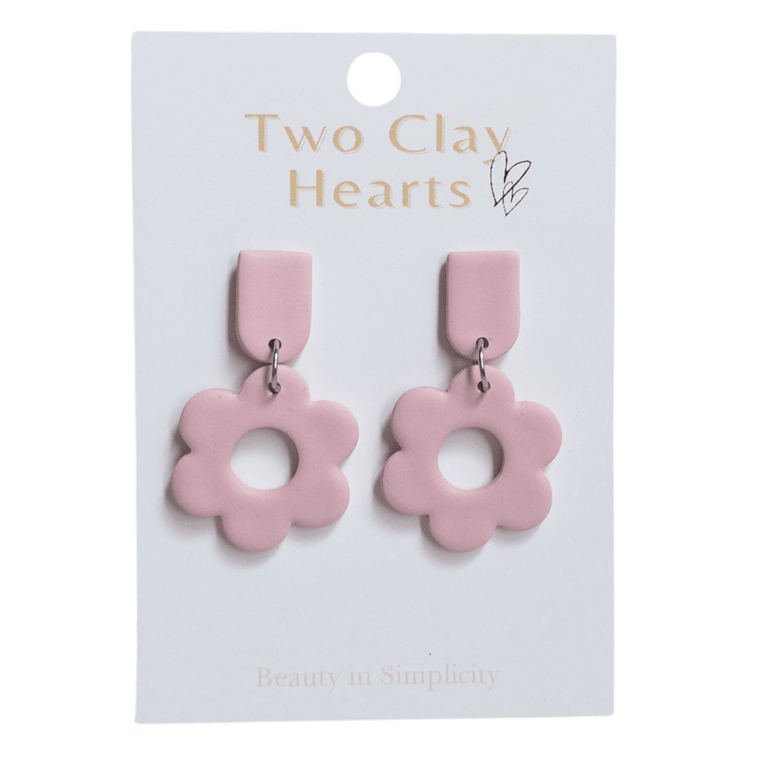 A pair of plain pink flower shaped dangle earrings