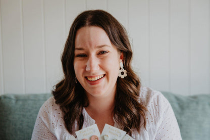 Simple flower dangle earrings worn on a model