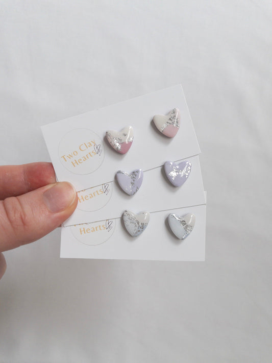 Pastel and silver heart shaped stud earrings on white backing card