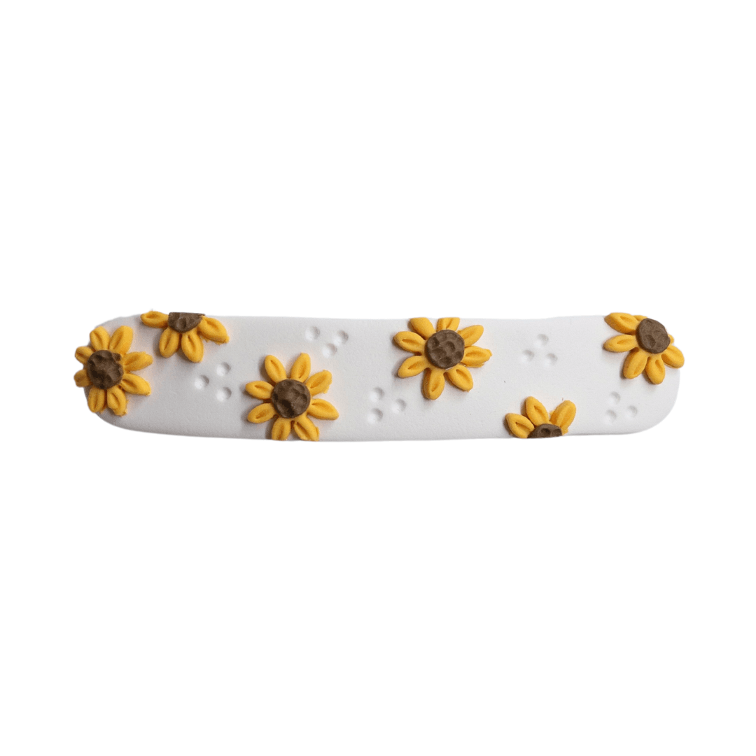 Close up on long sunflower polymer clay hair barrette