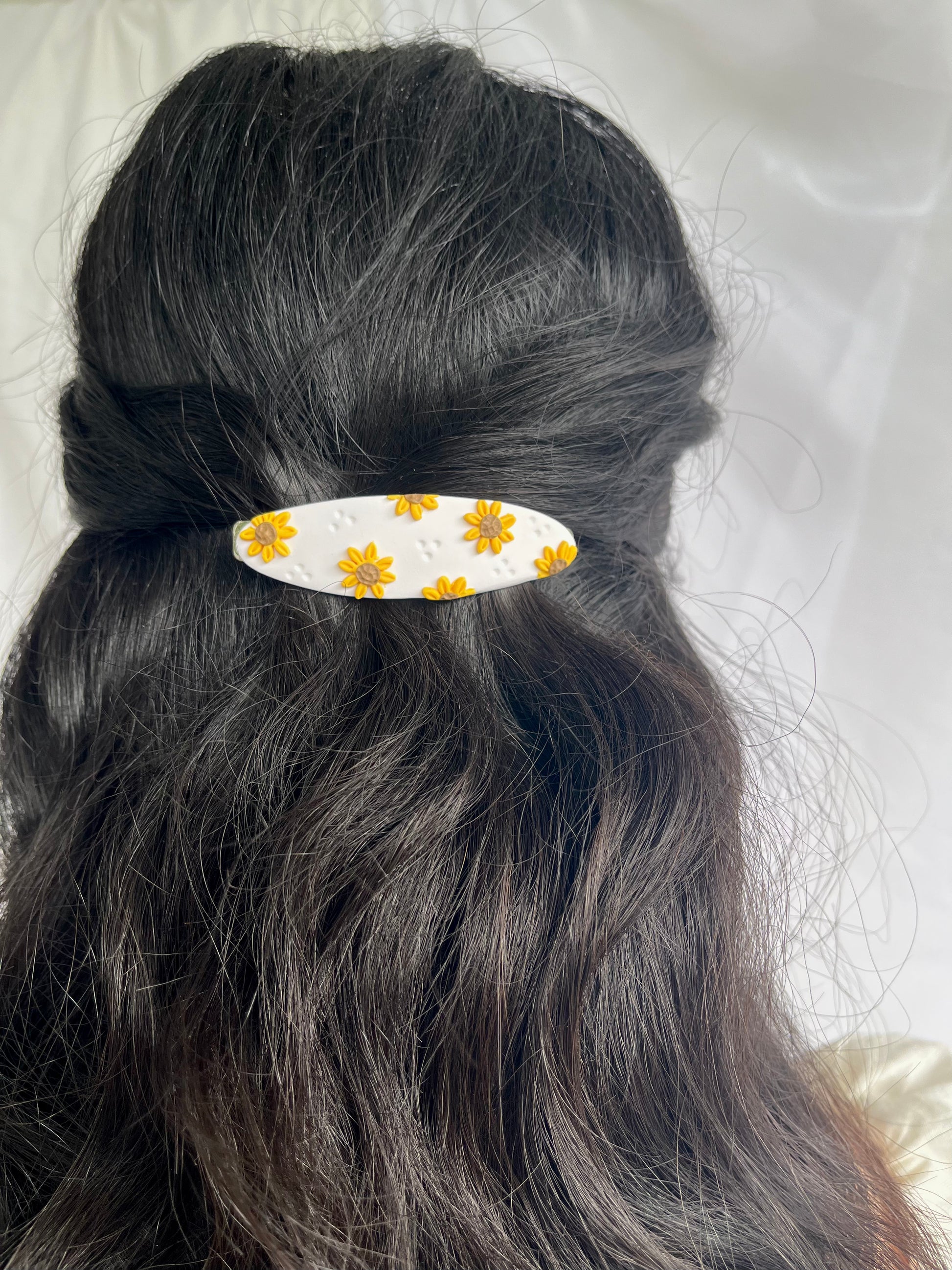 Sunflower hair barrette in models hair