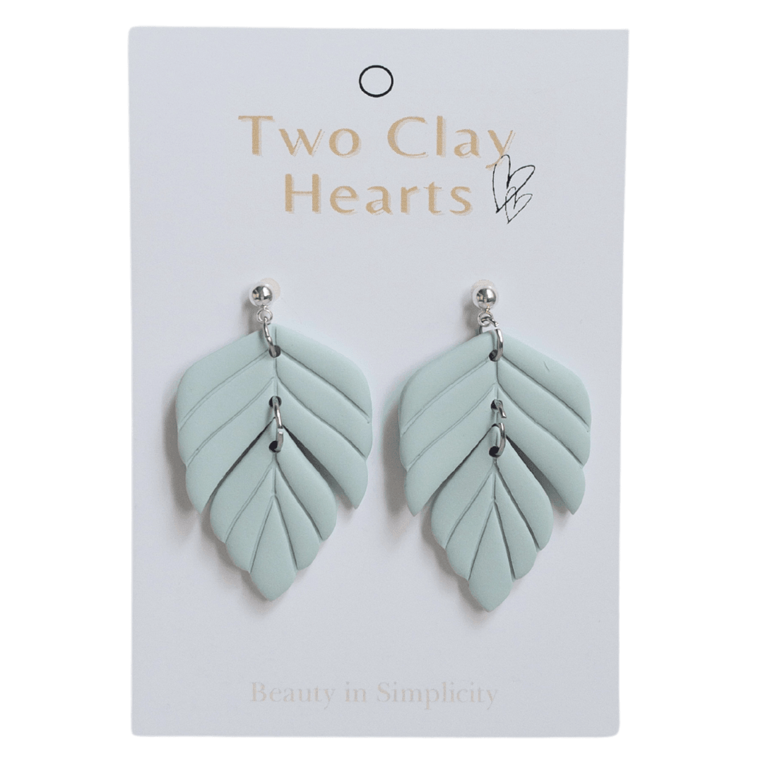 Light green polymer clay statement earring on white backing card